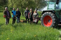 Veranstalter vor Doppelmessermähwerk am Traktor